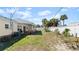 Landscaped backyard with a covered patio and a white fence offering privacy at 11 Briggs Dr, Ormond Beach, FL 32176