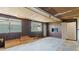 A spacious basement with wood paneled walls, windows and door to the outside at 11 Briggs Dr, Ormond Beach, FL 32176