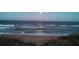 Picturesque beach view with a full moon over the ocean at night at 11 Briggs Dr, Ormond Beach, FL 32176