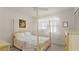 Serene bedroom featuring a four-poster bed, soft natural light, and classic decor at 11 Briggs Dr, Ormond Beach, FL 32176