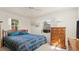Bright bedroom featuring a bed, chest of drawers, and natural light, offering a cozy and inviting atmosphere at 11 Briggs Dr, Ormond Beach, FL 32176