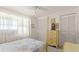 Comfortable bedroom with a four-poster bed, soft natural light, and classic decor at 11 Briggs Dr, Ormond Beach, FL 32176