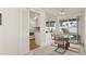 Bright dining area with sliding glass doors and view of the backyard, adjacent to kitchen with white cabinets and appliances at 11 Briggs Dr, Ormond Beach, FL 32176