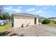 Exterior angle view of a quaint home with a well-maintained lawn and a paved driveway at 11 Briggs Dr, Ormond Beach, FL 32176