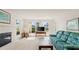 Bright living room featuring a cozy fireplace, large windows with ocean views, and comfortable furnishings for relaxing and entertaining at 11 Briggs Dr, Ormond Beach, FL 32176