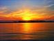 Vibrant sunset over calm waters, creating a stunning reflection and tranquil scene at 11 Briggs Dr, Ormond Beach, FL 32176
