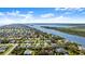 Real estate aerial view of a community along a river, highlighting the subject property with a yellow arrow at 111 Heron Dunes Dr, Ormond Beach, FL 32176