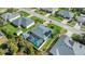 Aerial view of a private residence boasting a screened-in pool, solar panels, and meticulously maintained landscaping at 111 Heron Dunes Dr, Ormond Beach, FL 32176