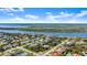 Real estate aerial showcasing a neighborhood with a river and lake backdrop, pointing to this property at 111 Heron Dunes Dr, Ormond Beach, FL 32176
