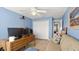 Bright bedroom featuring a ceiling fan, closet, and desk, offering comfortable living space at 111 Heron Dunes Dr, Ormond Beach, FL 32176