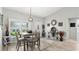 Well-lit dining area features a modern chandelier and a view of the outdoors at 111 Heron Dunes Dr, Ormond Beach, FL 32176