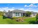 Well-maintained home featuring a lush green lawn and tropical landscaping at 111 Heron Dunes Dr, Ormond Beach, FL 32176