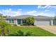 Charming single-story home with a well-maintained lawn and a two-car garage at 111 Heron Dunes Dr, Ormond Beach, FL 32176