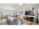 Cozy living room features a modern sofa, large windows, and vaulted ceilings at 111 Heron Dunes Dr, Ormond Beach, FL 32176