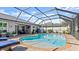 Backyard swimming pool is fully screened and features pavers and outdoor seating at 111 Heron Dunes Dr, Ormond Beach, FL 32176