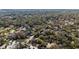 An aerial perspective of a neighborhood featuring homes nestled among mature trees at 128 Pine Cone Trl, Ormond Beach, FL 32174