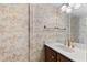 Small bathroom with floral wallpaper, vanity, sink, and lighting at 128 Pine Cone Trl, Ormond Beach, FL 32174