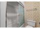 Bathroom with a shower stall, toilet, and floral wallpaper at 128 Pine Cone Trl, Ormond Beach, FL 32174