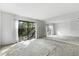 Bright living room with mirrored wall and sliding glass doors to the yard at 128 Pine Cone Trl, Ormond Beach, FL 32174