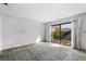 Sunlit living room with large sliding glass doors overlooking the backyard at 128 Pine Cone Trl, Ormond Beach, FL 32174