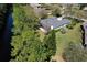 An aerial view of a well-maintained home with a large yard and mature trees bordering a canal at 1432 Kinnard Cir, Ormond Beach, FL 32174