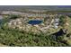 Breathtaking aerial view of a golf community home on the water surrounded by trees at 1432 Kinnard Cir, Ormond Beach, FL 32174