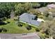 Aerial view showcases the home's backyard, mature trees, and green spaces at 1432 Kinnard Cir, Ormond Beach, FL 32174