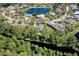 Beautiful aerial view of a home in a community by a lake and creek surrounded by trees at 1432 Kinnard Cir, Ormond Beach, FL 32174