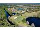 Scenic aerial view of a home in a golf course community on the water at 1432 Kinnard Cir, Ormond Beach, FL 32174