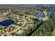 Scenic aerial view of a home nestled in a lush community with a golf course and various waterways at 1432 Kinnard Cir, Ormond Beach, FL 32174