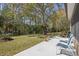 Scenic backyard with mature trees, lush greenery, and access to water at 1432 Kinnard Cir, Ormond Beach, FL 32174