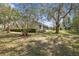 Expansive backyard featuring mature trees and lush landscaping at 1432 Kinnard Cir, Ormond Beach, FL 32174