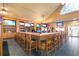 Stylish bar area featuring a long wooden bar, multiple televisions, and comfortable seating at 1432 Kinnard Cir, Ormond Beach, FL 32174