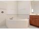 Bright bathroom featuring a soaking tub with tile surround and a vanity at 1432 Kinnard Cir, Ormond Beach, FL 32174