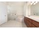 Bright bathroom featuring a glass shower, soaking tub, and vanity with a sink at 1432 Kinnard Cir, Ormond Beach, FL 32174
