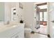 Bathroom with a white vanity, and a door opening to a sunroom filled with plants at 1432 Kinnard Cir, Ormond Beach, FL 32174