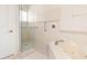 Bathroom featuring a soaking tub, glass shower, and white tile surround at 1432 Kinnard Cir, Ormond Beach, FL 32174