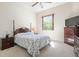Comfortable bedroom with a window and dresser with a television at 1432 Kinnard Cir, Ormond Beach, FL 32174