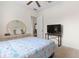 This bedroom is furnished with a wooden dresser, mirror, and a mounted TV on a sleek black stand at 1432 Kinnard Cir, Ormond Beach, FL 32174