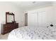 Cozy bedroom featuring wood dresser, mirror and a double door closet at 1432 Kinnard Cir, Ormond Beach, FL 32174