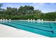The community pool with clear blue water is lined with lounge chairs, perfect for sunny relaxation at 1432 Kinnard Cir, Ormond Beach, FL 32174