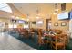 Spacious dining area featuring tables, chairs, and wall-mounted TVs, perfect for casual meals and gatherings at 1432 Kinnard Cir, Ormond Beach, FL 32174