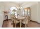Formal dining room with hardwood floors, large window, and elegant decor at 1432 Kinnard Cir, Ormond Beach, FL 32174