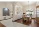Elegant dining room open to other living spaces with hardwood floors, a large window, and a china cabinet at 1432 Kinnard Cir, Ormond Beach, FL 32174