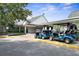 Exterior view of clubhouse featuring covered parking and several golf carts ready for a day on the course at 1432 Kinnard Cir, Ormond Beach, FL 32174