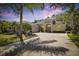 Elegant home featuring lush landscaping, a circular driveway, and a grand arched entryway at 1432 Kinnard Cir, Ormond Beach, FL 32174