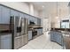 Open kitchen featuring gray cabinets, stainless steel appliances, and tile floors at 1432 Kinnard Cir, Ormond Beach, FL 32174
