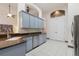 The kitchen offers gray cabinets, quartz countertops, stainless steel appliances, and ample cabinet space at 1432 Kinnard Cir, Ormond Beach, FL 32174