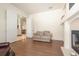 Living room with wood flooring, fireplace, and open doorway to the dining room at 1432 Kinnard Cir, Ormond Beach, FL 32174