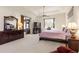 Spacious main bedroom with plush carpet, ceiling fan, sitting area and large windows at 1432 Kinnard Cir, Ormond Beach, FL 32174
